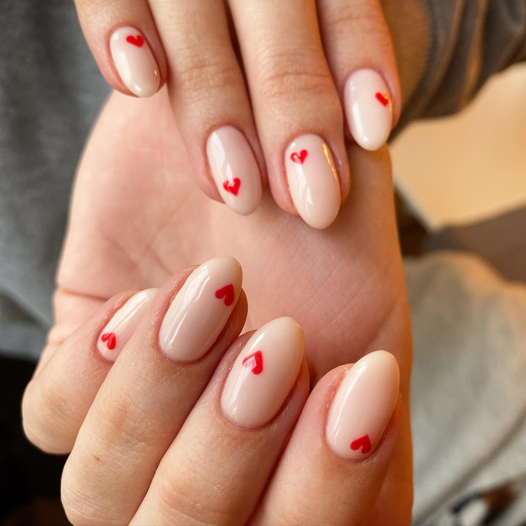 nail art with nude valentines and cute hearts design.