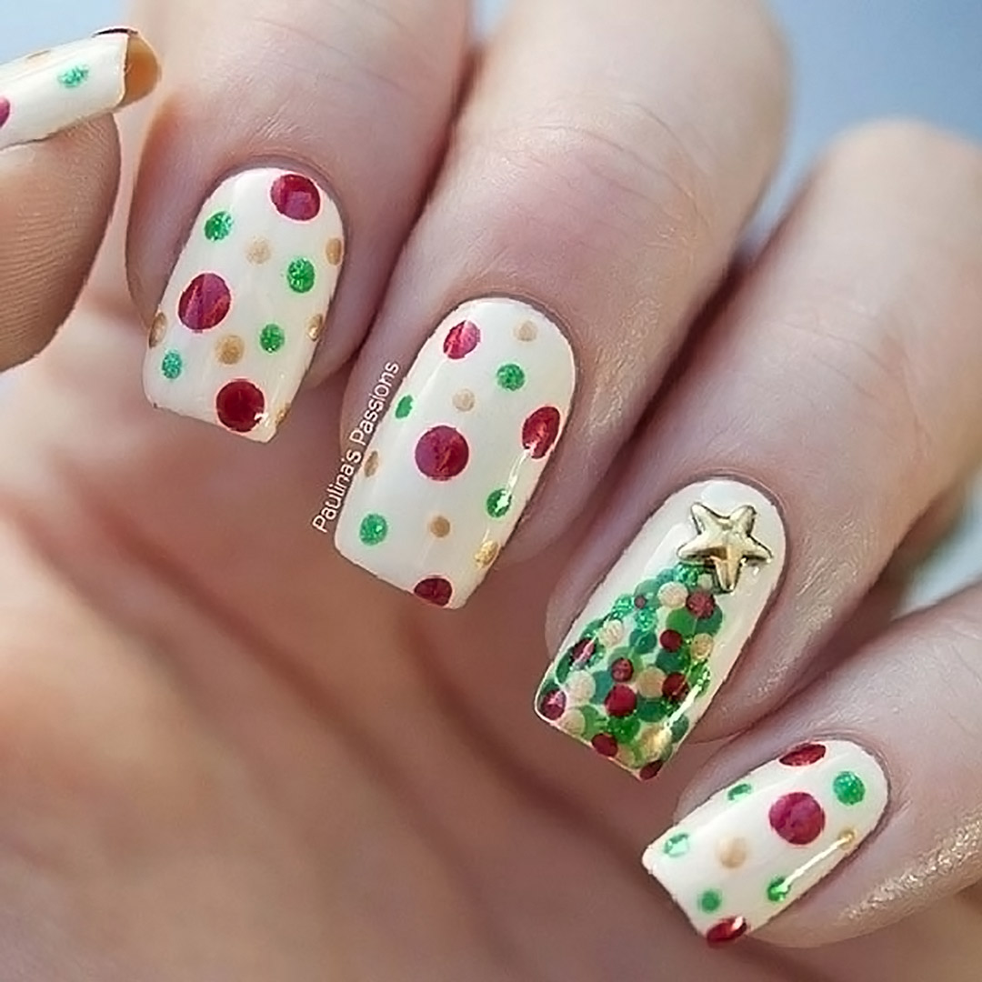 White nails with polka dots and a Christmas tree.