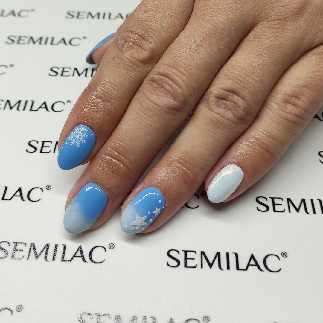 Nails with blue winter sky design.