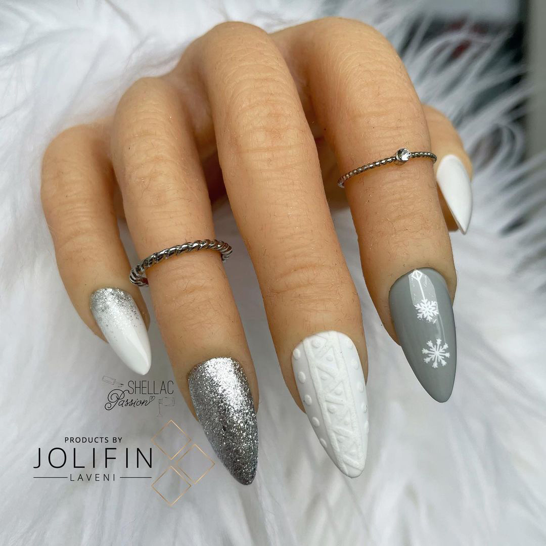 Nails with silver french snowflake design.