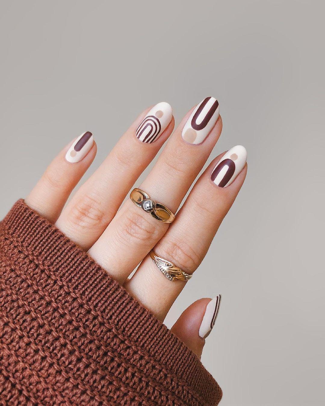 Nail set styled with mid-century-modern arches.