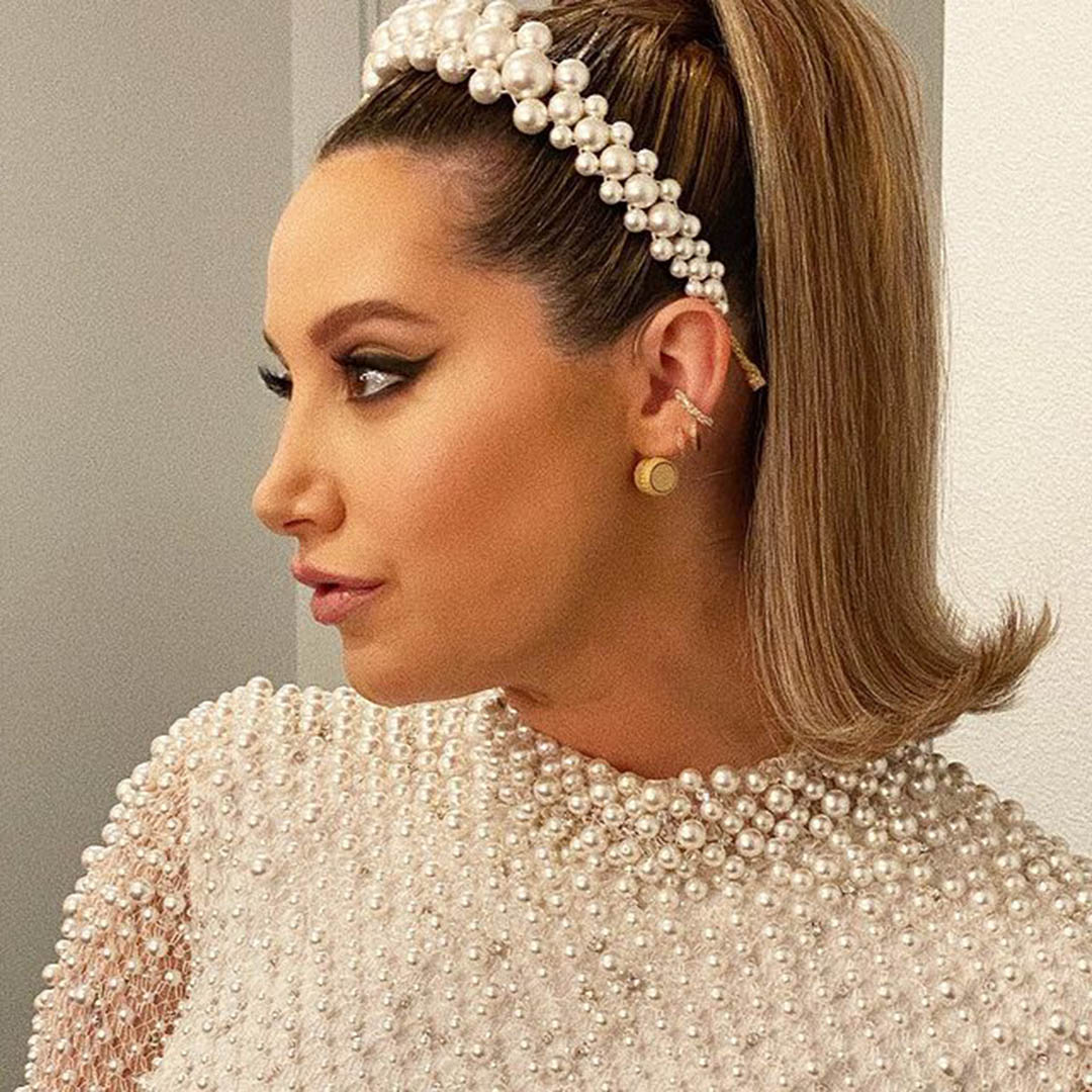 Woman with a pearl-bedecked headband.