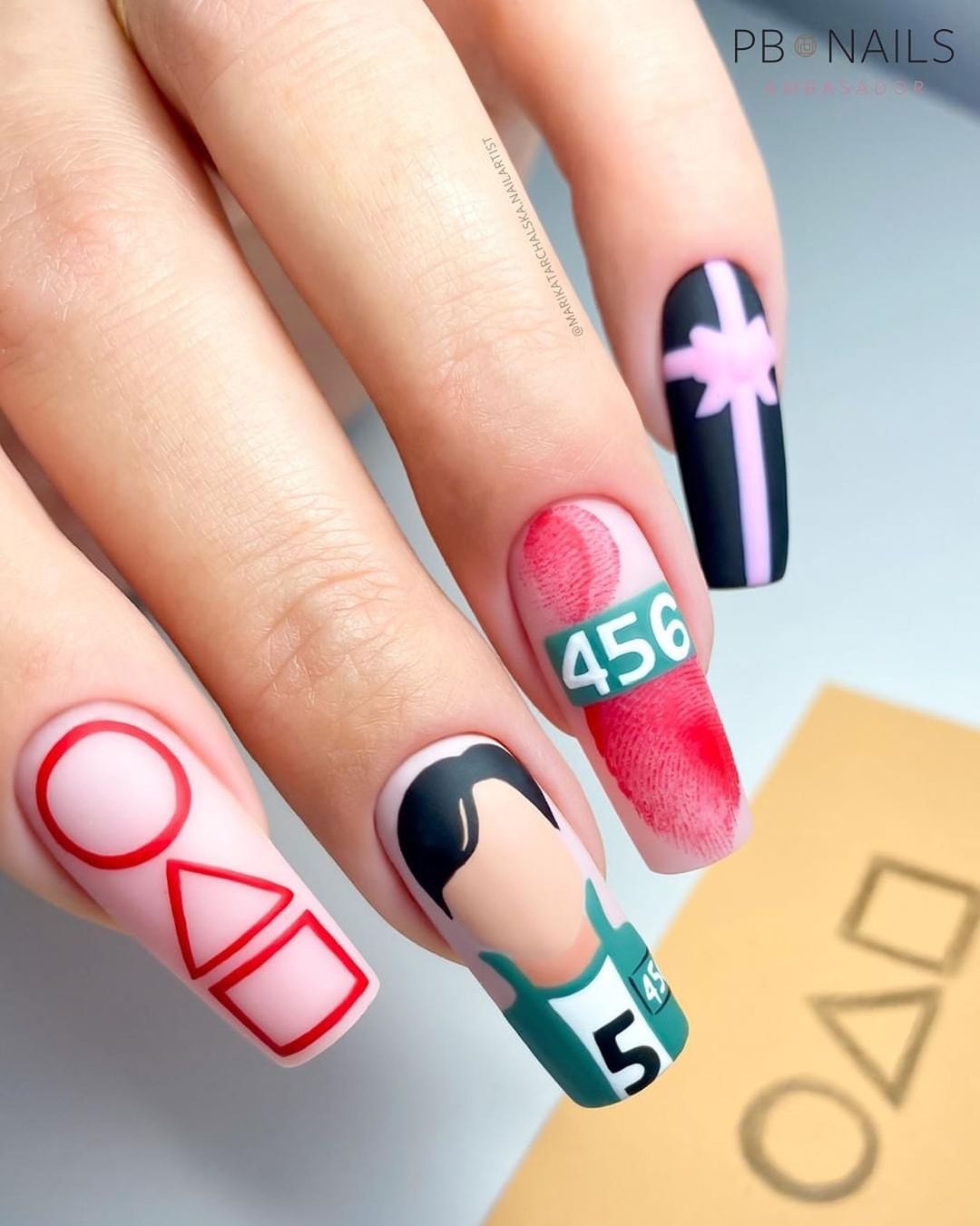 Nails with Squid Game art.