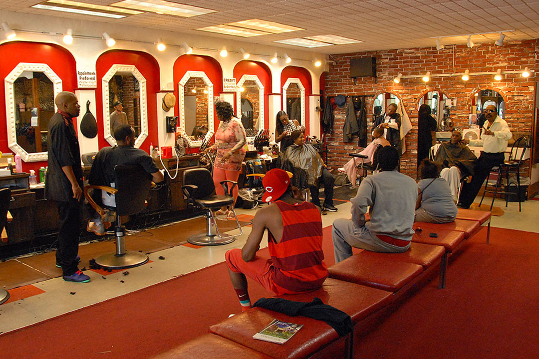 A barbershop with stylists and clients.