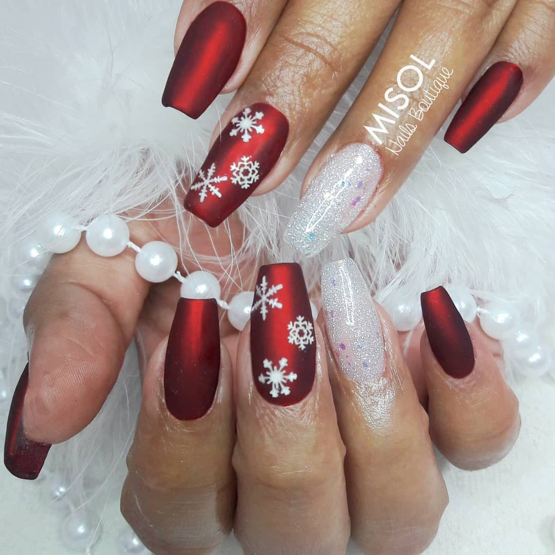 Nails with a red festivity theme.
